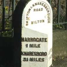 Milestone, metal plate attached to stone post, Skipton Road, Bilton, in front of Bilton Grange school