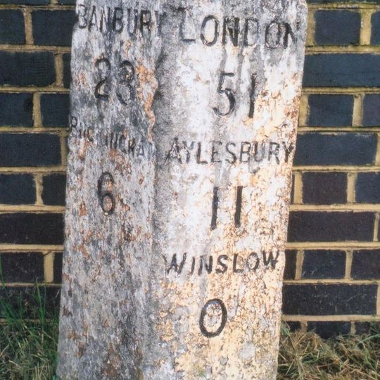 Milestone, Buckingham Road; NW edge of railway bridge parapet, by jct. with B4033