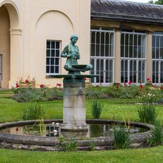 Circular Pond With Central Fountain And Statue