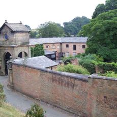 Gatehouse, flanking walls and bollards to Maer Hall