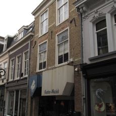 Huis met witgeschilderde lijstgevel en overblijfselen van jaarankers