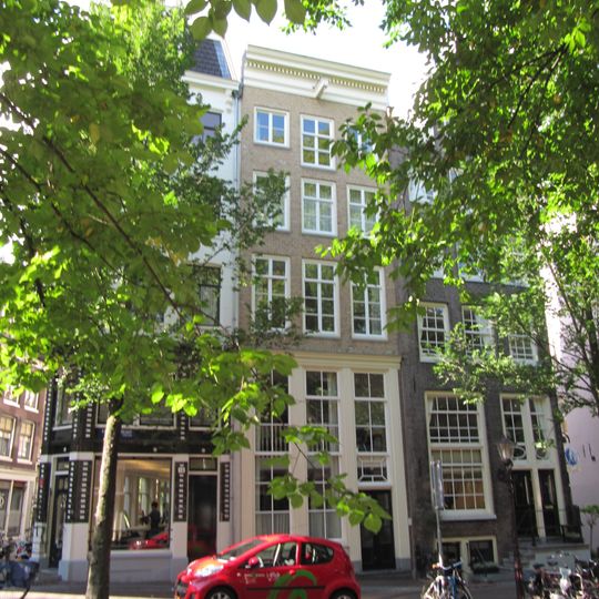 Hoekhuis, halsgevel met gedeelde vleugelstukken en palmet in de afdeling