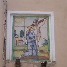 Ceramic panel of Saint Francis hugging Christ