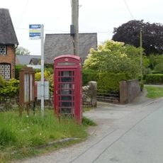 Telephone kiosk on green to front of Lilac Cottage