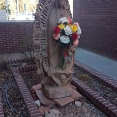 Saint Mary holding a bouquet of flowers