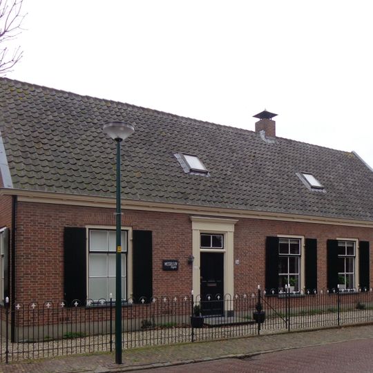 Boerderij, langgerekte gepleisterde gevel, met zadeldak