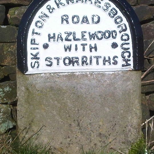 Milestone, jct of Storiths Lane, 1 mile E of TI with B6160