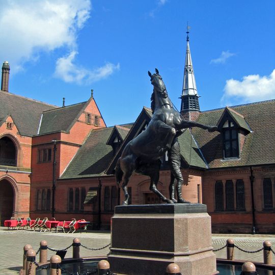 Equestrian statue and plinth at centre of stable yard
