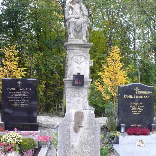 Tombstones and sculpture of the Man of Sorrows