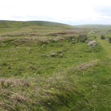 Round cairn 850m, and two Romano-British farmsteads, associated trackway, moated site, medieval settlement and field system 900m