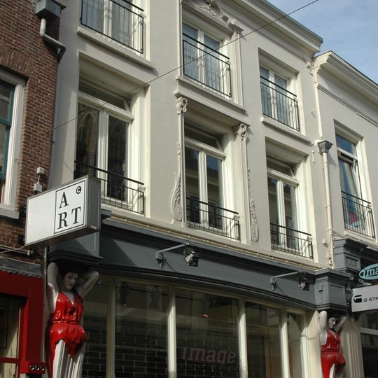 Pand bestaande uit drie bouwlagen, een kap loodrecht op de straat en verschillende kelders, onder andere een werfkelder