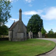 Lodge, gates, piers and screens to forecourt between Coach-House Court and Eaton Hall Cottages