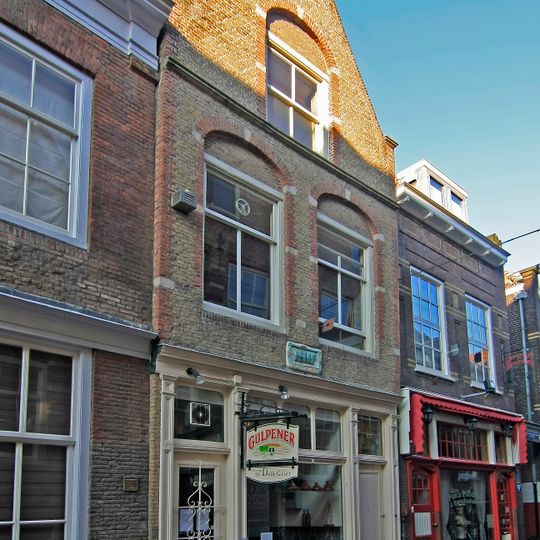 Tegenover de "Berckepoort" staand pand met tot puntgevel gewijzigde trapgevel met geblokte vensterneggen en tegen de geprofileerde waterlijst