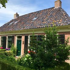 Pand met voorgoot op klosjes onder schilddak met hoekschoorstenen (vormt een geheel met nr. 14)