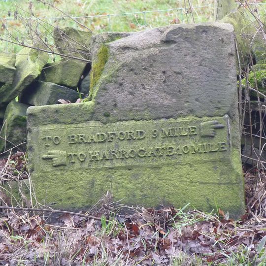 Milestone, Harrogate Road, just SW of jct with A660  at SE24074397
