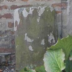 Parish boundary stone against front wall of No.60 (The Old Glass House)