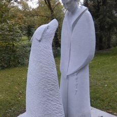 Socha svatého Františka z Assisi s vlkem z Gubbia v parku u domu Šlajferka