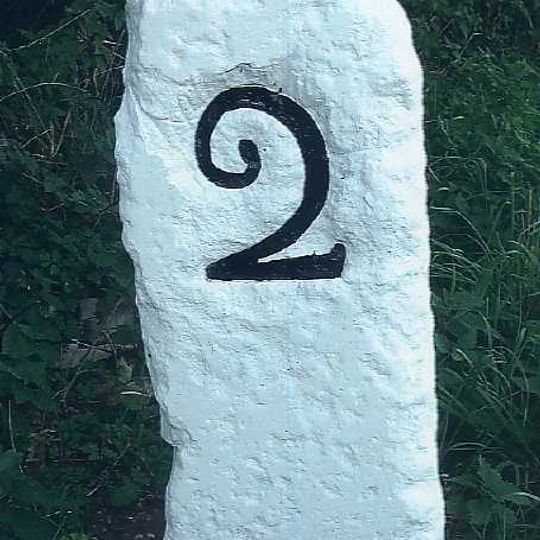 Milestone, 50yds E of roundabout