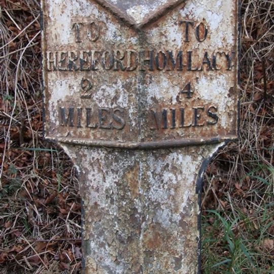 Milepost, W of Industrial estate; 200m from railway bridge