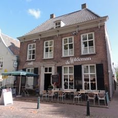 Huis met strenge lijstgevel, kroonlijst met régence-consoles