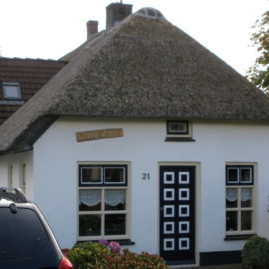 Gepleisterde kleine hoeve onder rieten wolfdak