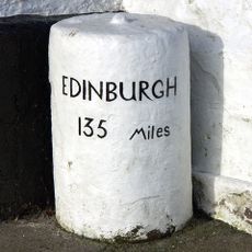 Milestone, Highgate main street; by Highgate Hotel