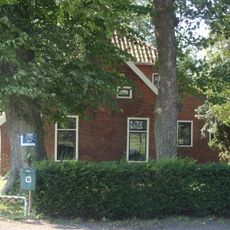 Boerderij met kort voorhuis tegen hoger opgaande schuur waarin de ingang tot de woning is gevat