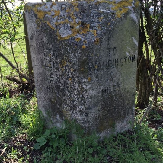 Milestone, Warrington Road, Risley; opp.  Rowe Farm against hedgerow
