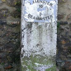 Milestone, 100m from junction with B3162 by shop and pub