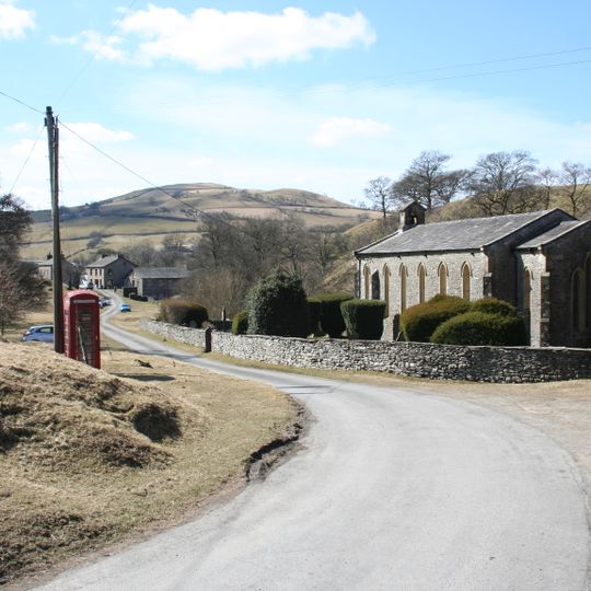 K6 telephone kiosk approximately 20 metres south east of Holy Trinity churchyard